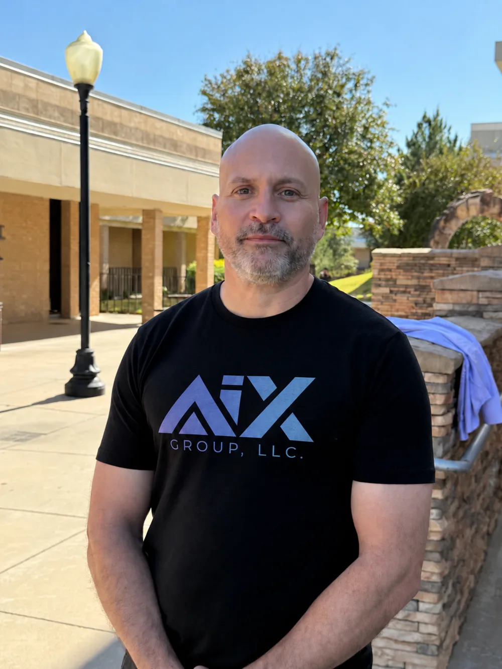 Nick Craven outdoors in an AIX Group t-shirt